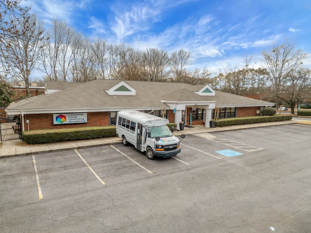 Chroma Early Learning Academy building in Roswell, GA with daycare bus parked outside, showcasing the welcoming environment for families seeking quality childcare.