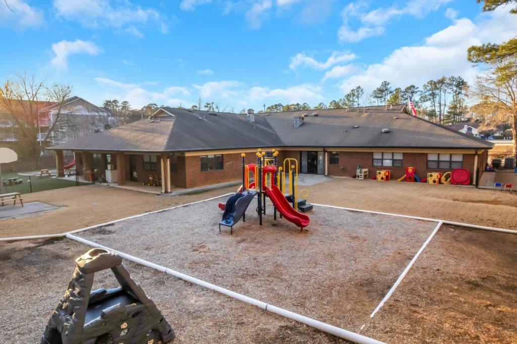 Playground area at Chroma Early Learning Academy's Satellite Blvd Campus in Duluth, GA, featuring colorful play structures, a sandbox, and a safe, nurturing environment for children's activities.