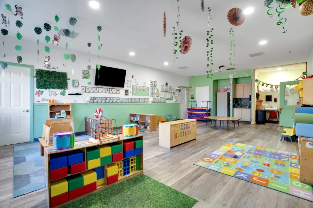 Brightly decorated classroom at Cherokee Academy featuring colorful educational toys, a play area with a patterned rug, and a nurturing environment for early childhood learning.