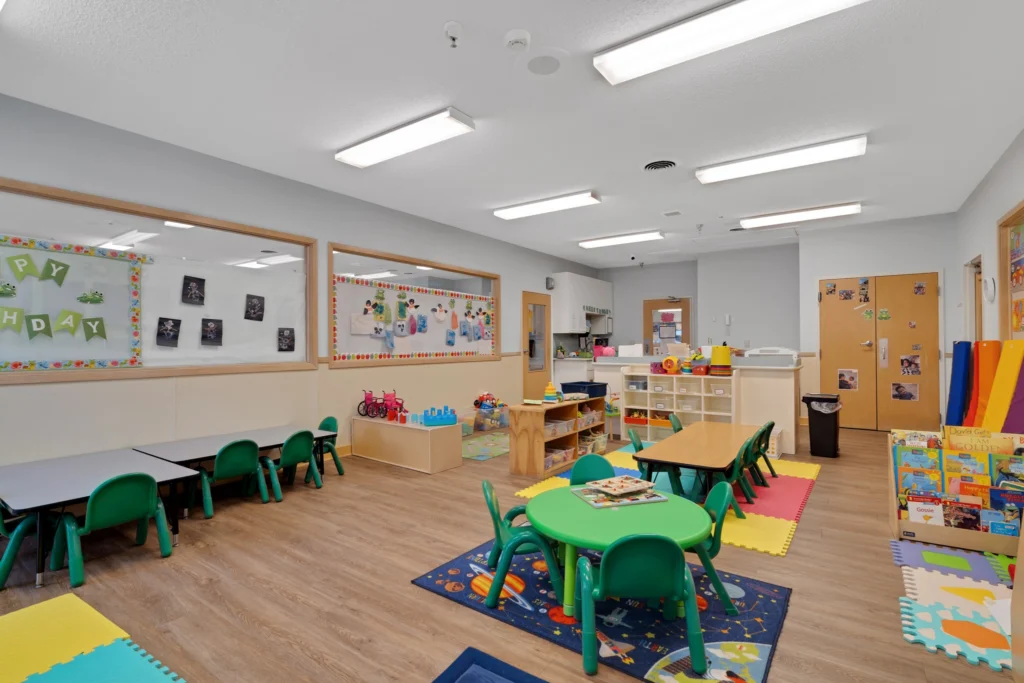 Brightly lit classroom at Chroma Early Learning Academy featuring colorful tables and chairs, educational toys, and cheerful decorations for a nurturing childcare environment in Duluth, GA.