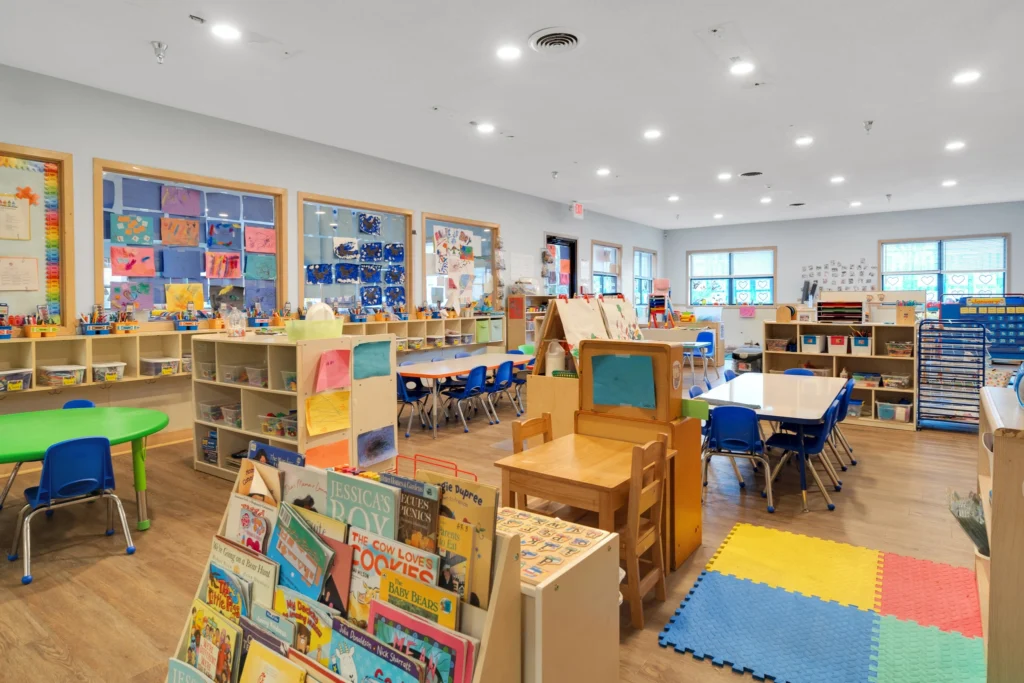 Bright and colorful classroom at Chroma Early Learning Academy with child-sized furniture, educational materials, and art displays, promoting a nurturing environment for children aged 6 weeks to 12 years in Duluth, GA.