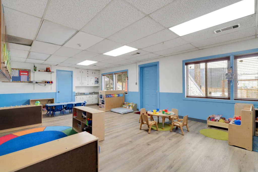 Bright and inviting classroom at Chroma Early Learning Academy, featuring colorful rugs, child-sized furniture, and play areas, designed for nurturing early childhood education in Duluth, GA.