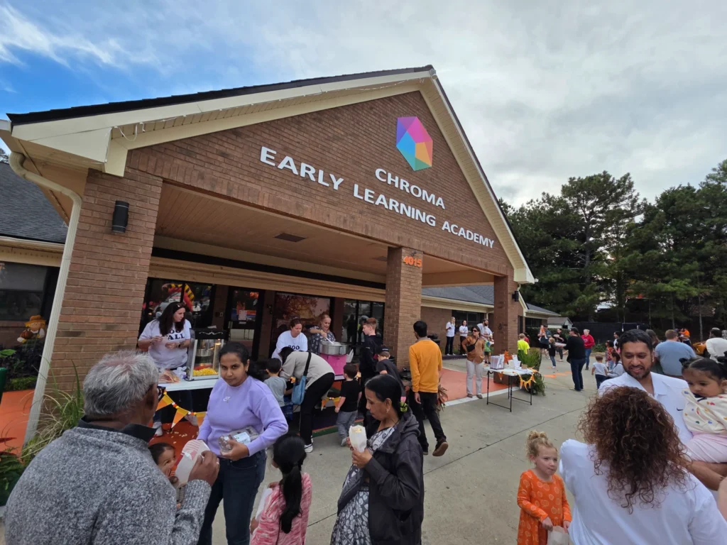 Chroma Early Learning Academy's Tramore Campus exterior with families and staff engaging in activities, showcasing community involvement and early education programs.