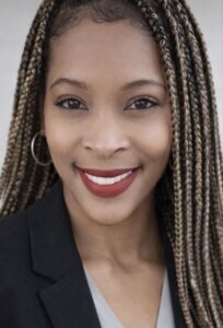 Morgan Powell, Lead Billing Specialist at Chroma Early Learning Academy, smiling with braided hair and professional attire, representing dedication to early childhood education and community values.